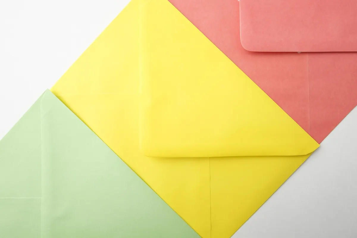 Three overlapping envelopes in green, yellow and coral, standing for the three ways to run a business email address.