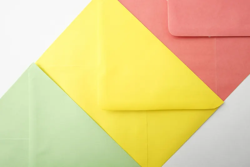 Three overlapping envelopes in green, yellow and coral, standing for the three ways to run a business email address.