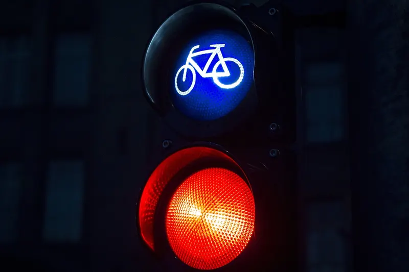 Traffic light showing a red stop signal under a blue bicycle signal