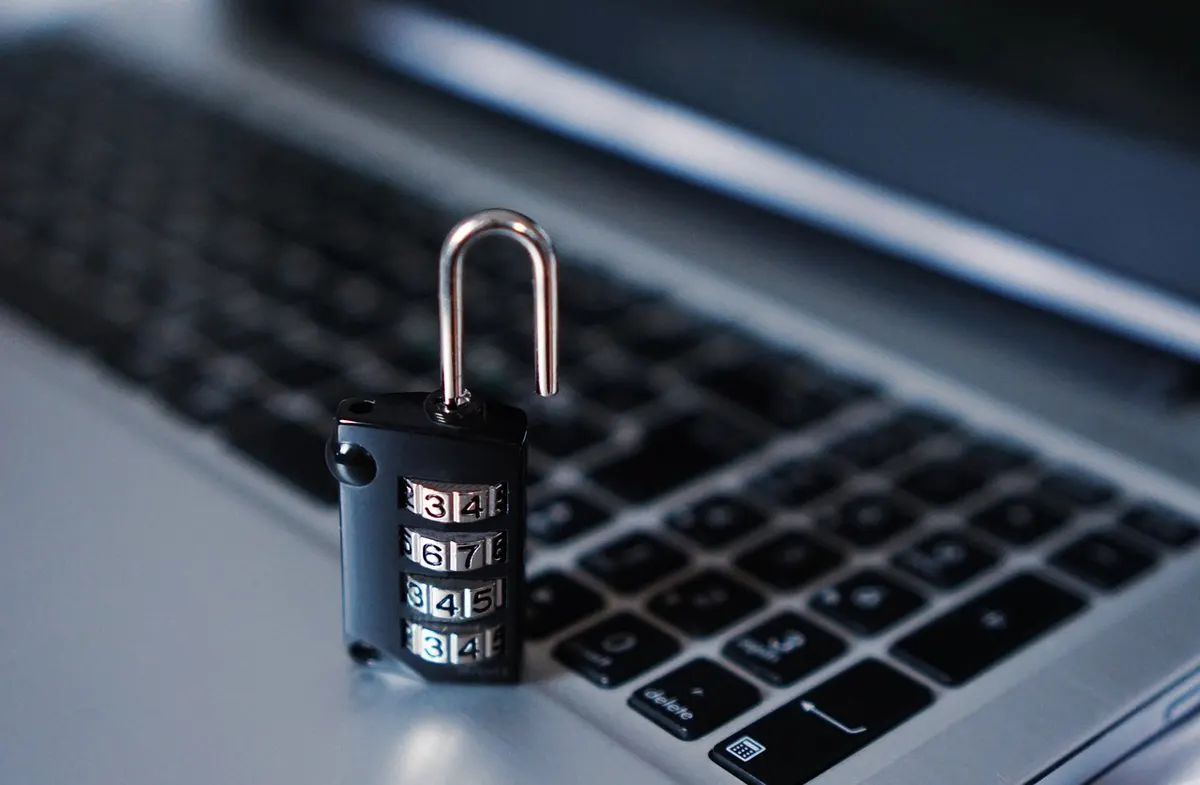 Combination padlock resting on a laptop keyboard