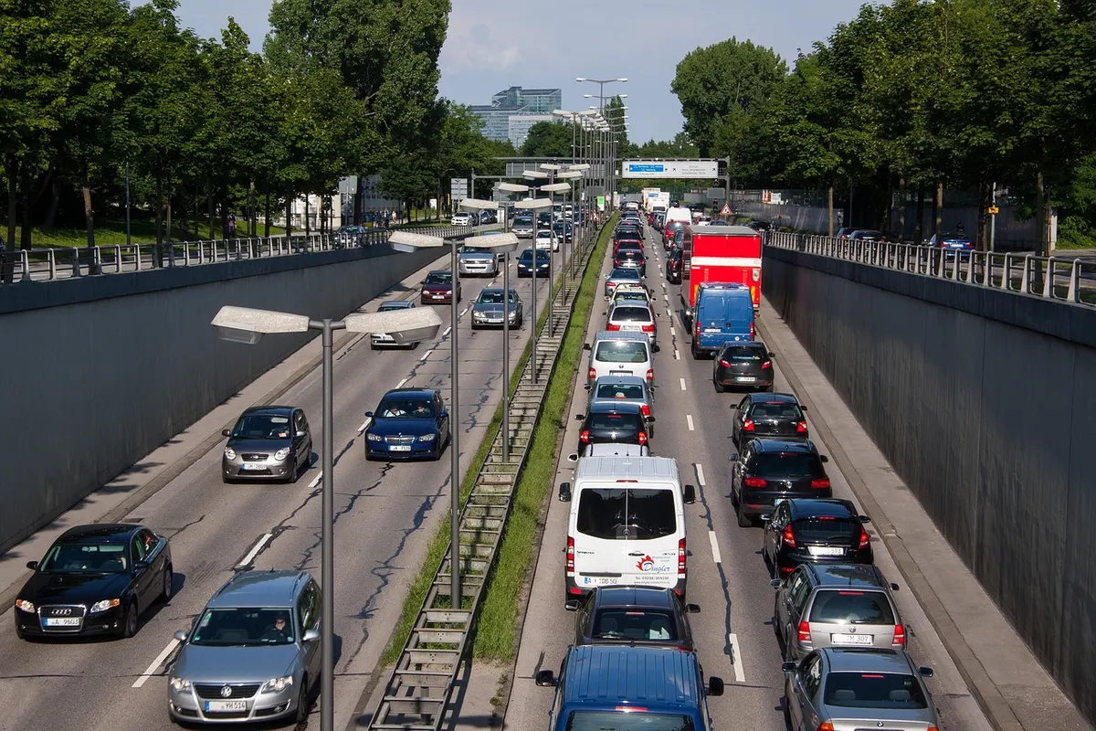 A dual carriageway packed with queuing cars and vans in both lanes, the road equivalent of a website swamped by traffic.