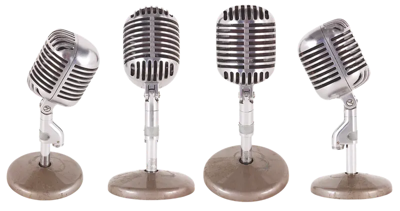 Four chrome vintage microphones on stands, each tilted at a different angle, like one voice adjusting its tone for different situations.