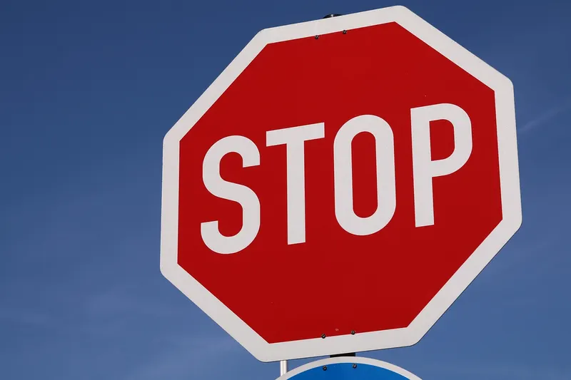Red octagonal stop sign against a blue sky, like a mail server refusing a message