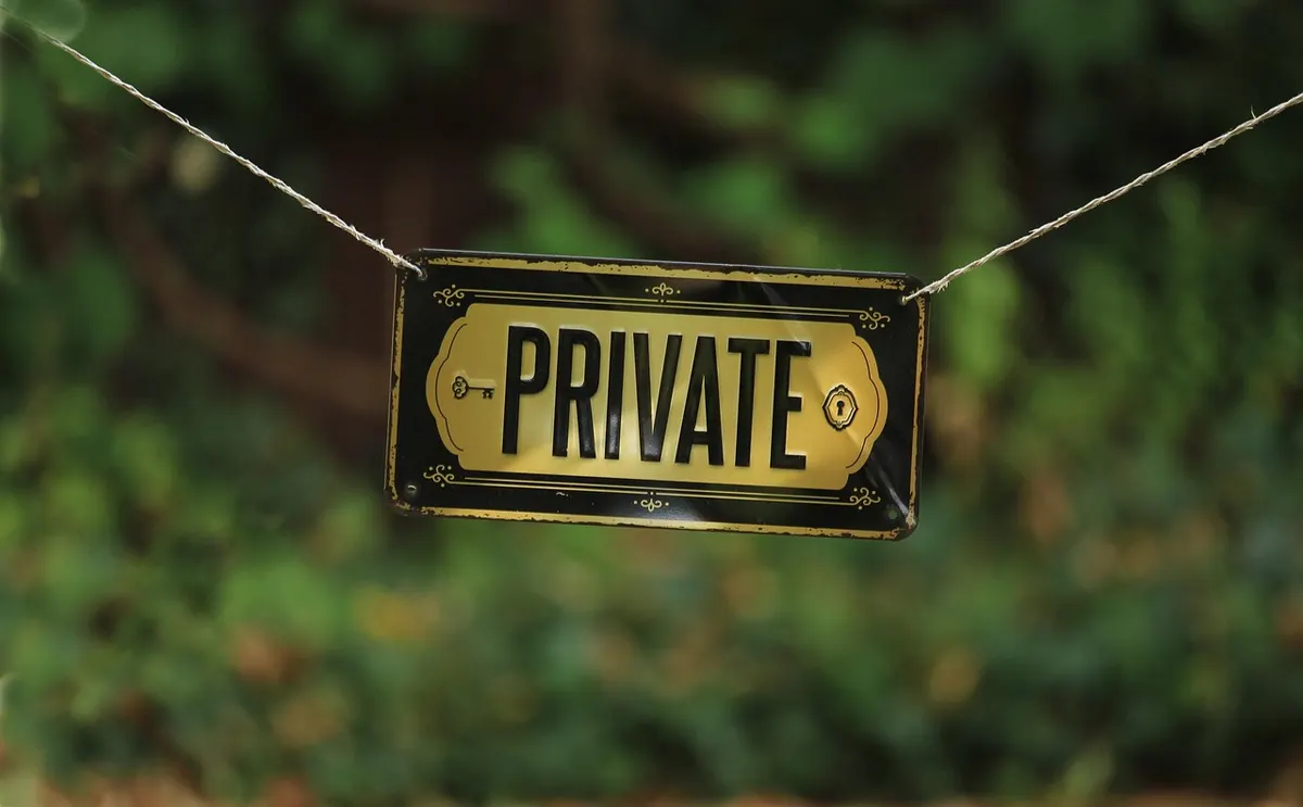 A black and gold sign reading Private hanging from a string, the public notice WHOIS privacy puts in place of your personal details.