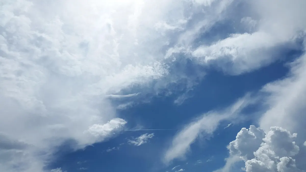 White cumulus clouds drifting across a bright blue sky, the inspiration behind a much-stretched hosting term.
