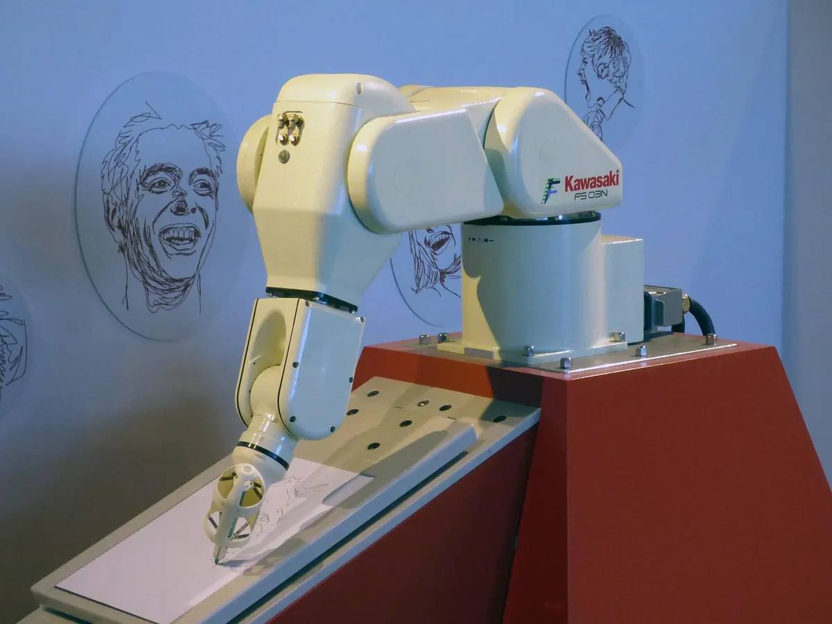 An industrial robot arm drawing a portrait in pen on paper, with finished sketches pinned on the wall behind it.