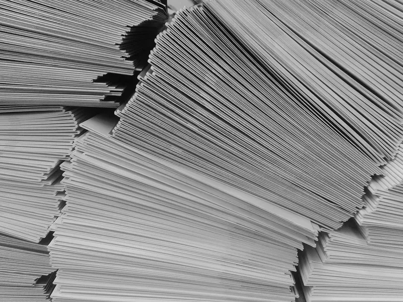 A tall stack of envelopes and letters seen side on, the scale bulk senders work at