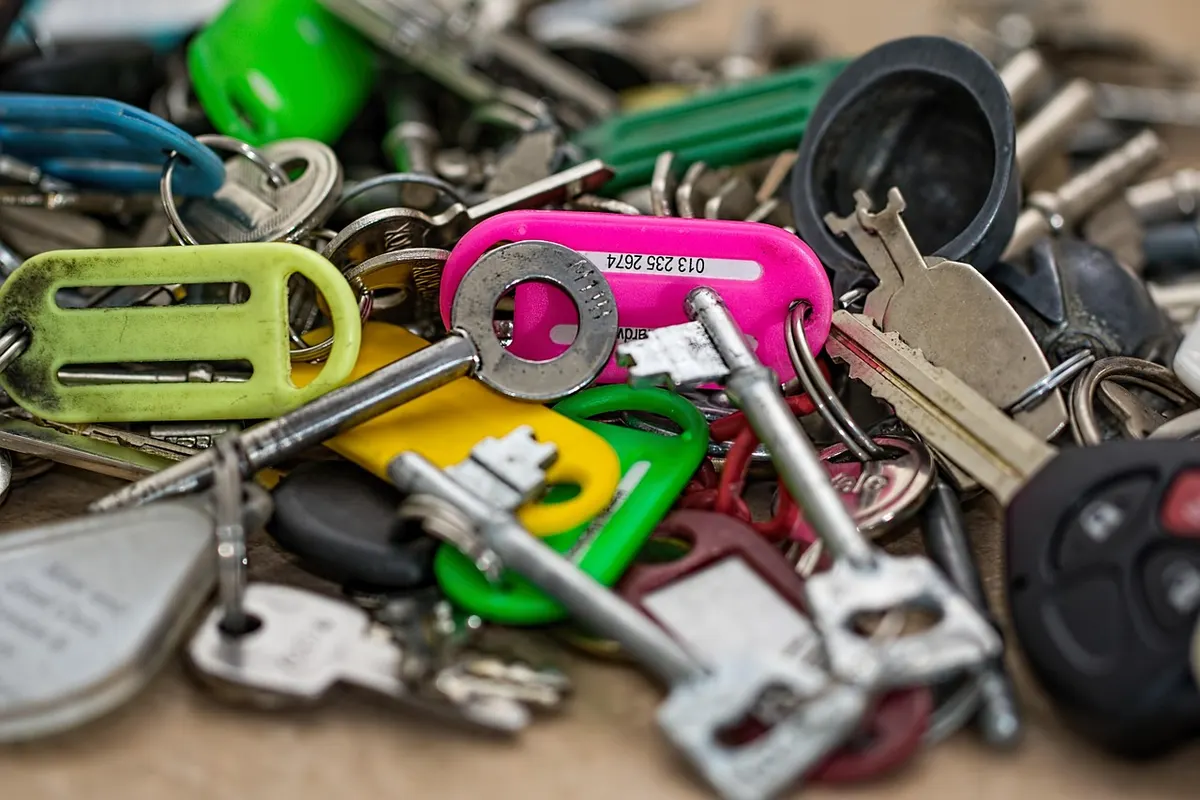 A pile of assorted keys with brightly coloured plastic tags, cheap and pricey ones alike that open their locks just as well.